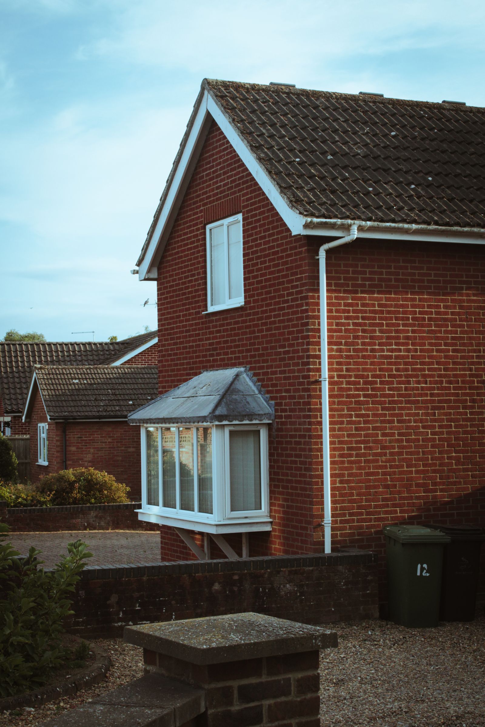Detached UK home with a maintained front garden and driveway